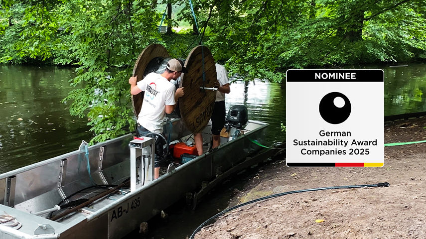 Drausy worker on boat with hose on drum